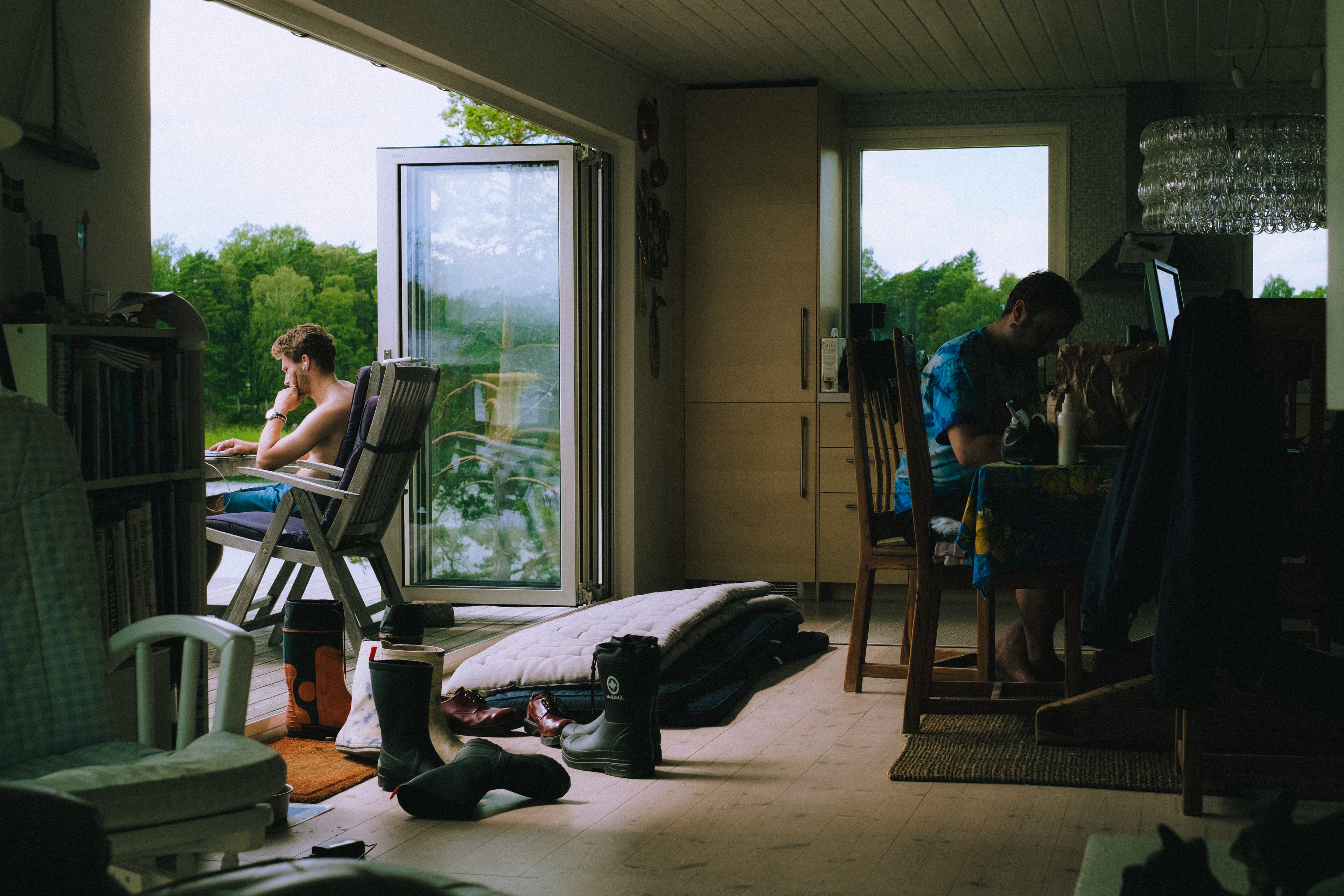 Two members of the collective working from a lakeside house.